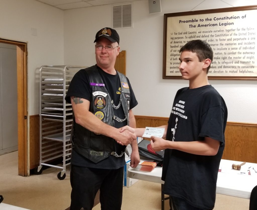 Jordan receiving donation from Legion Riders